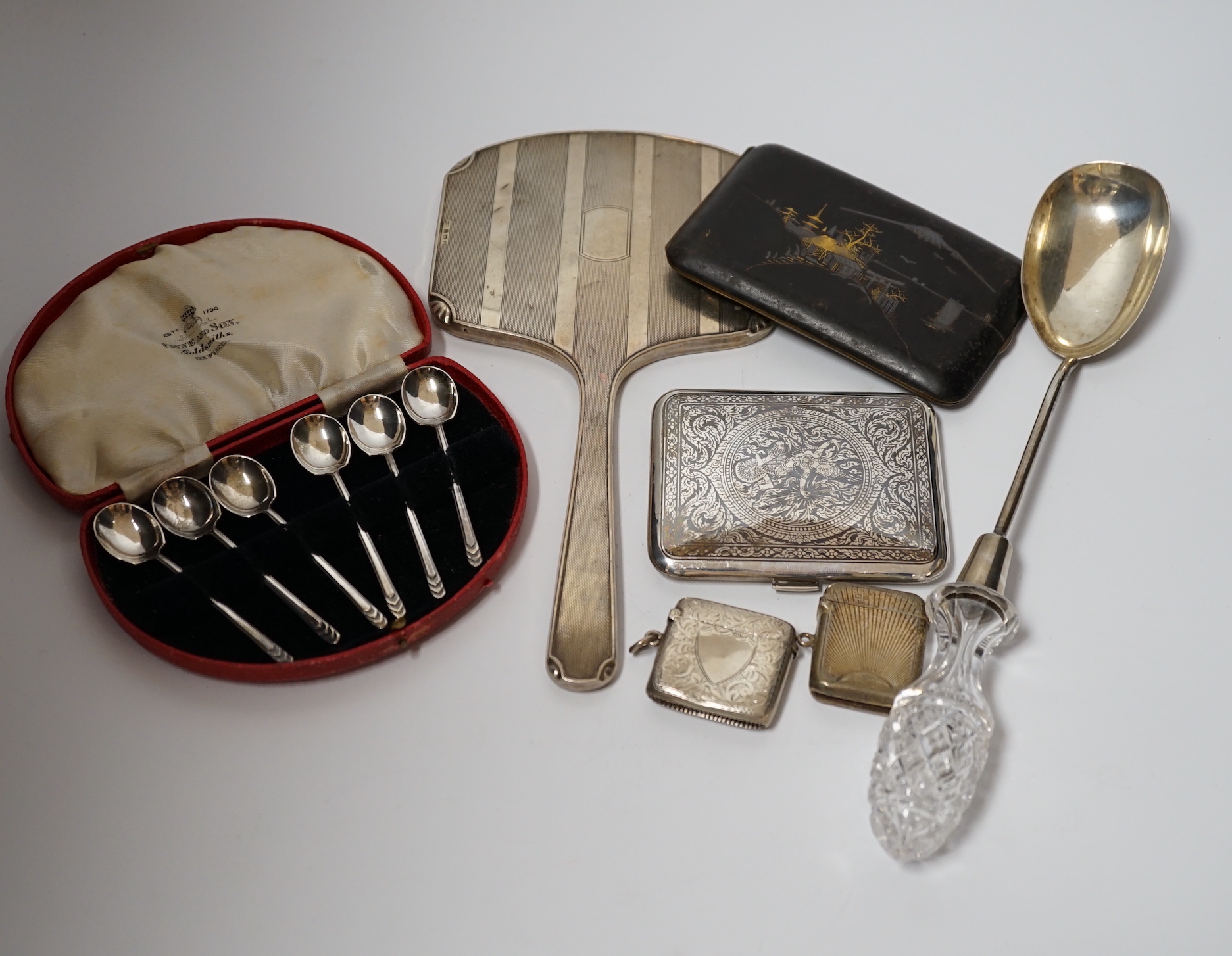 A quantity of assorted silver and sterling items including cigarette case, card case, vesta cases, mounted inkwell, glass handled salad server, plated vesta case, etc.